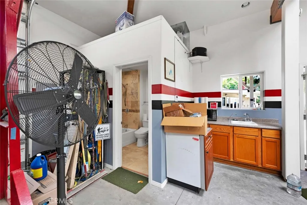 Inside of garage showing "wetbar" and bathroom entrance.