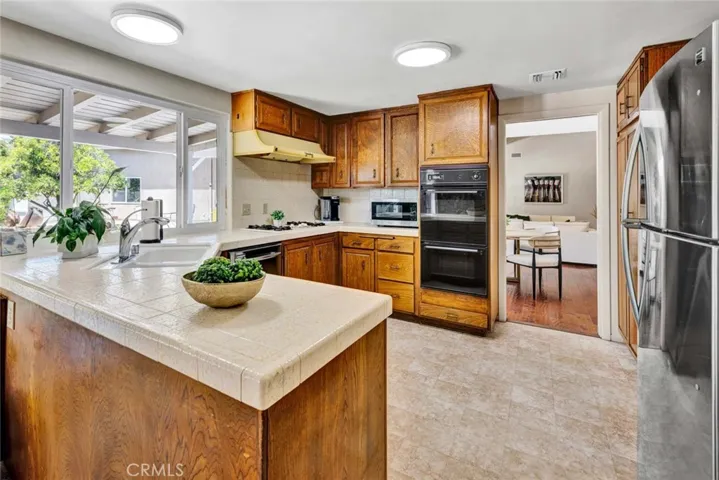U shaped kitchen with window overlooking patio and backyard.