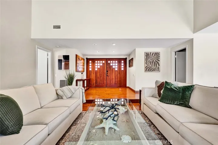Custom double entry wood doors and side lights.  Wood floor entry.