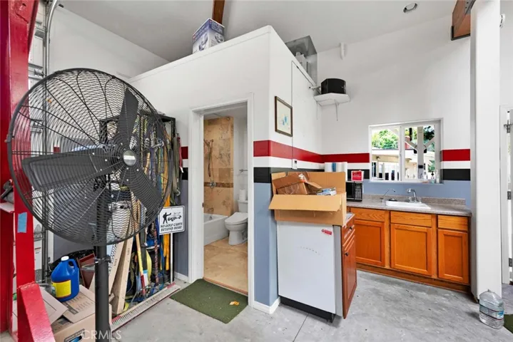 Inside of garage showing "wetbar" and bathroom entrance.
