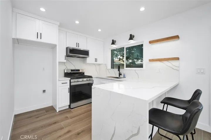 Kitchen/Dining features custom cabinetry and Quartz counterops