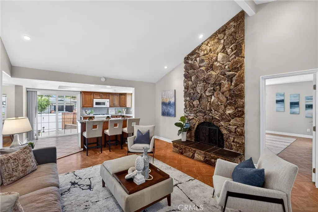 Stone fireplace, hardwood floors, and recessed lighting, high ceilings in family room