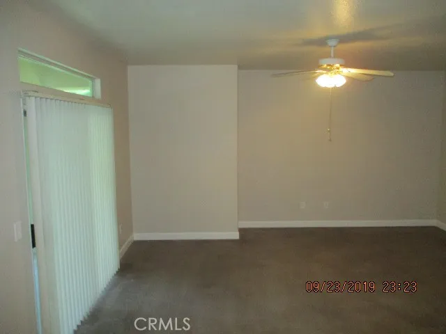 FAMILY ROOM WITH SLIDING GLASS DOOR TO THE REAR COVERED PATIO