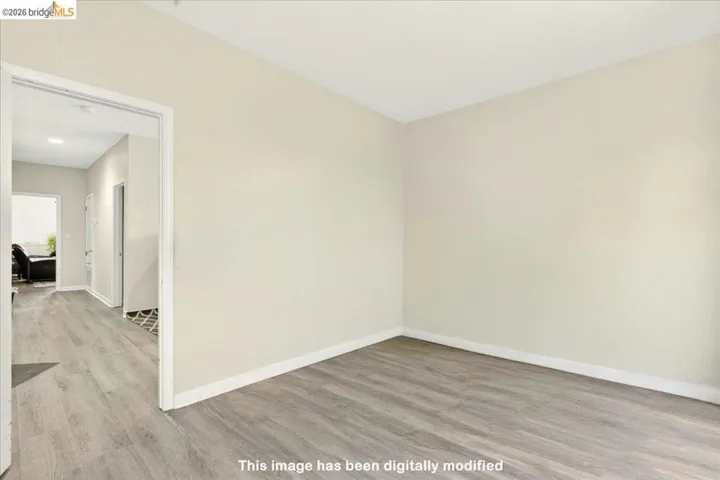 Neutral-toned wall finishes complement the wood-finish flooring