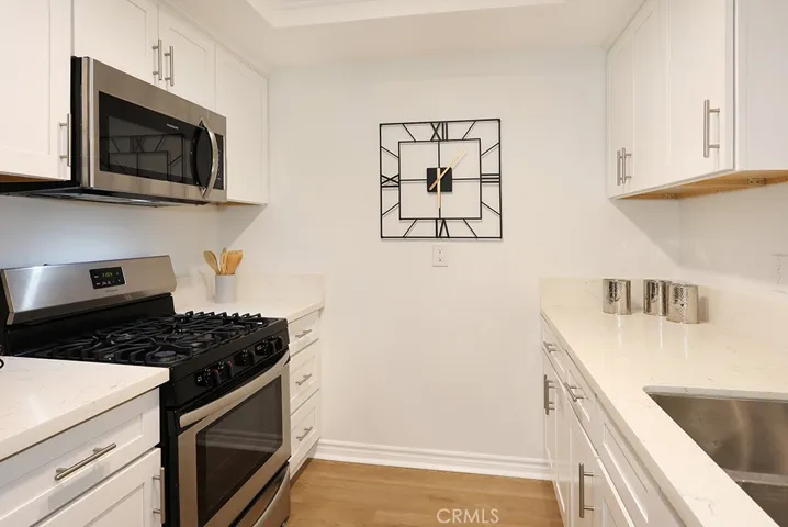 Dazzling kitchen with quartz counters and stainless steel appliances