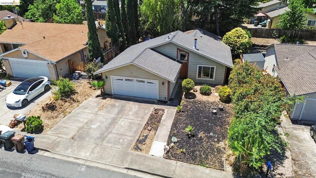 Single-story residence featuring a gray shingle roof and a two-car garage