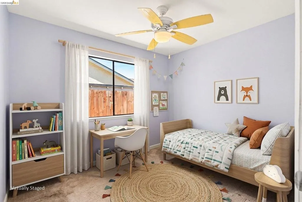 Room featuring wall-to-wall carpeting, a window with sheer curtains, and a ceiling fan with light fixture