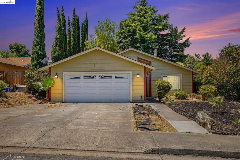 Single-story residence featuring a two-car garage with transom windows