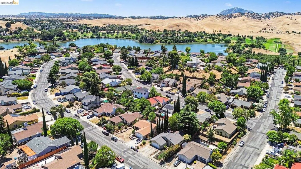Aerial perspective showcasing a residential community with winding streets, mature trees, and individual homes