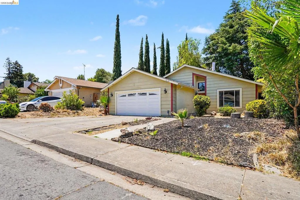 Single-story residence featuring a two-car garage and a paved driveway