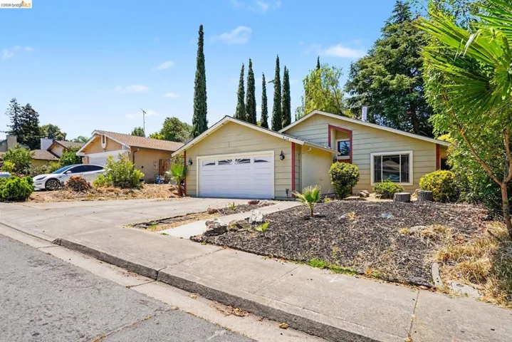 Single-story residence featuring a two-car garage and a paved driveway