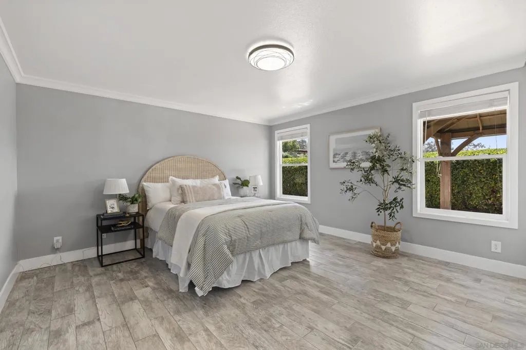 Bedroom looks out on beautiful foliage brick patio