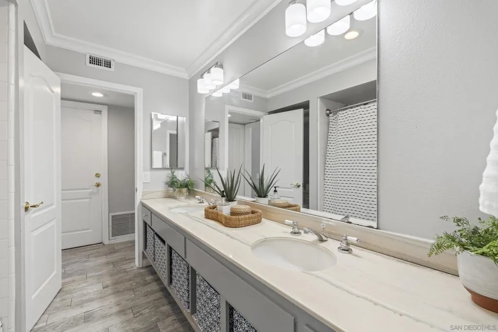 Dual sink bathroom with bathtub and shower in one