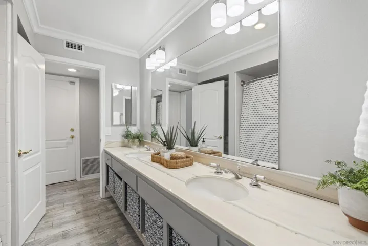 Dual sink bathroom with bathtub and shower in one