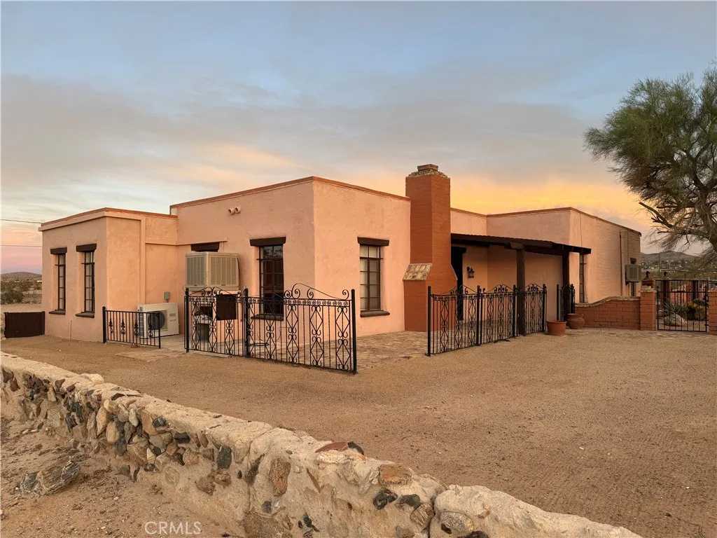 Historic custom Adobe home with Block wall and wrought iron fencing Historic custom Adobe home with Block wall and wrought iron fencing