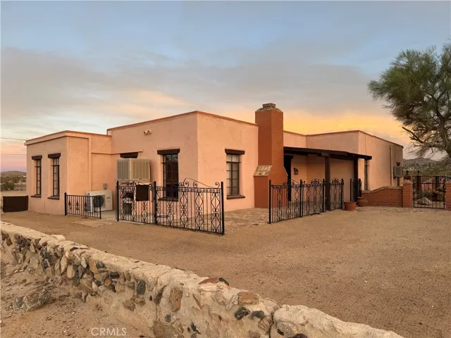 Historic custom Adobe home with Block wall and wrought iron fencing