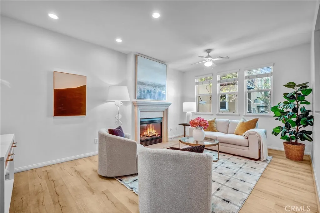 Living Space with Fireplace, Laminate Flooring showing bright and airy.