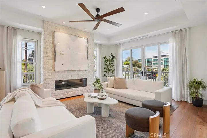 Family room with stone fireplace and wrap-around balcony