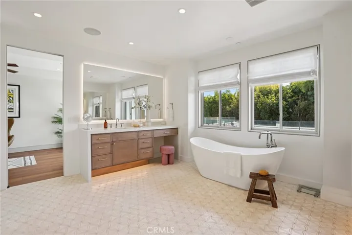 Primary bath with steam shower, soaking tub, dual vanities, and dual water closets