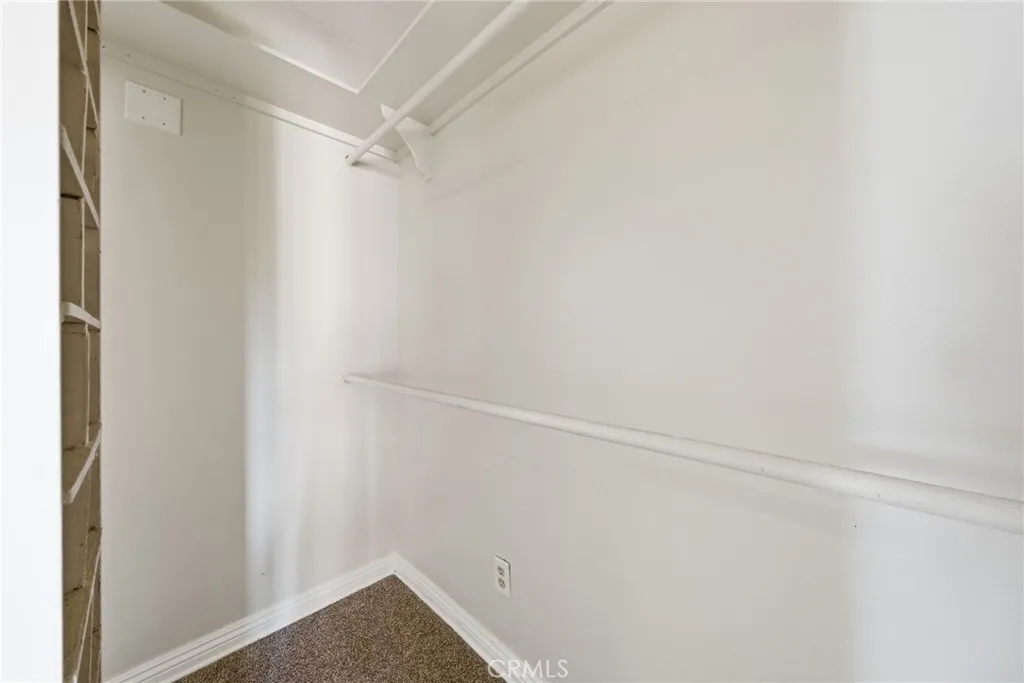 Walk in closet in the primary bedroom