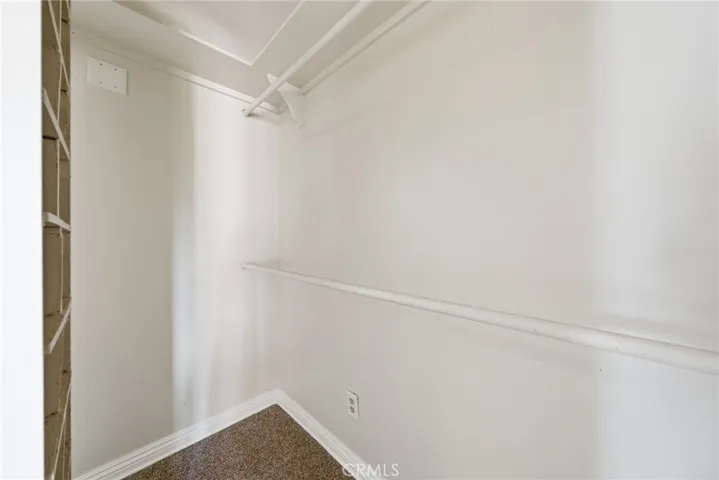 Walk in closet in the primary bedroom
