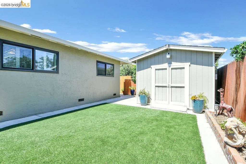 Expansive artificial turf lawn bordered by a paved pathway