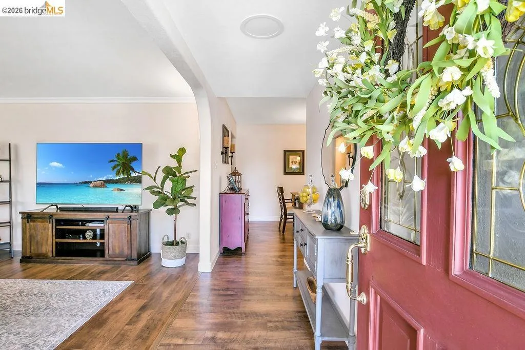 Entryway featuring a red paneled door with decorative glass inserts and brass hardware