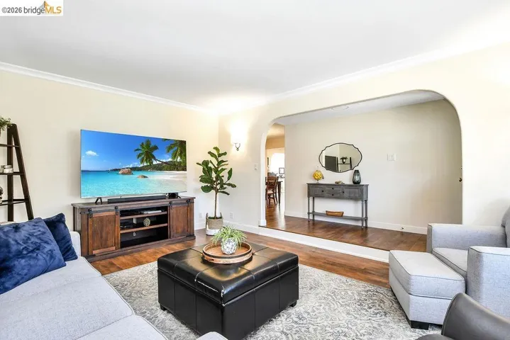 Living area featuring warm cream-colored walls and crown molding