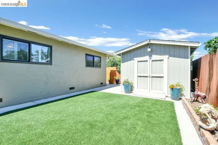 Expansive artificial turf lawn bordered by a paved pathway
