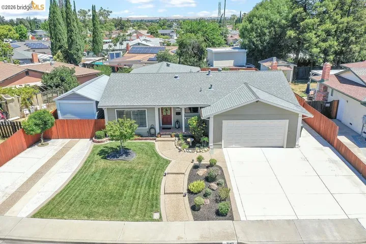 Single-story residence featuring an attached garage, a separate detached garage, and a concrete driveway