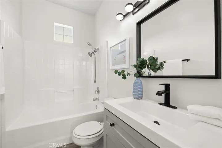 Secondary upstairs bath with modern vanity and lights