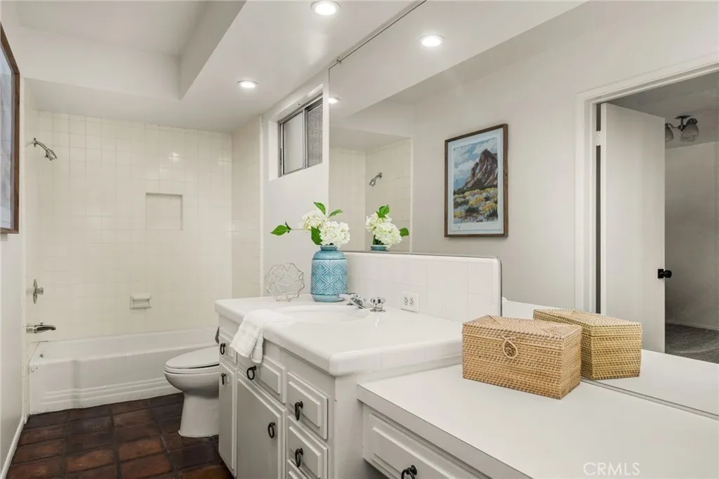 The powder/guest bath off foyer includes a tub, shower and attached guest bedroom.
