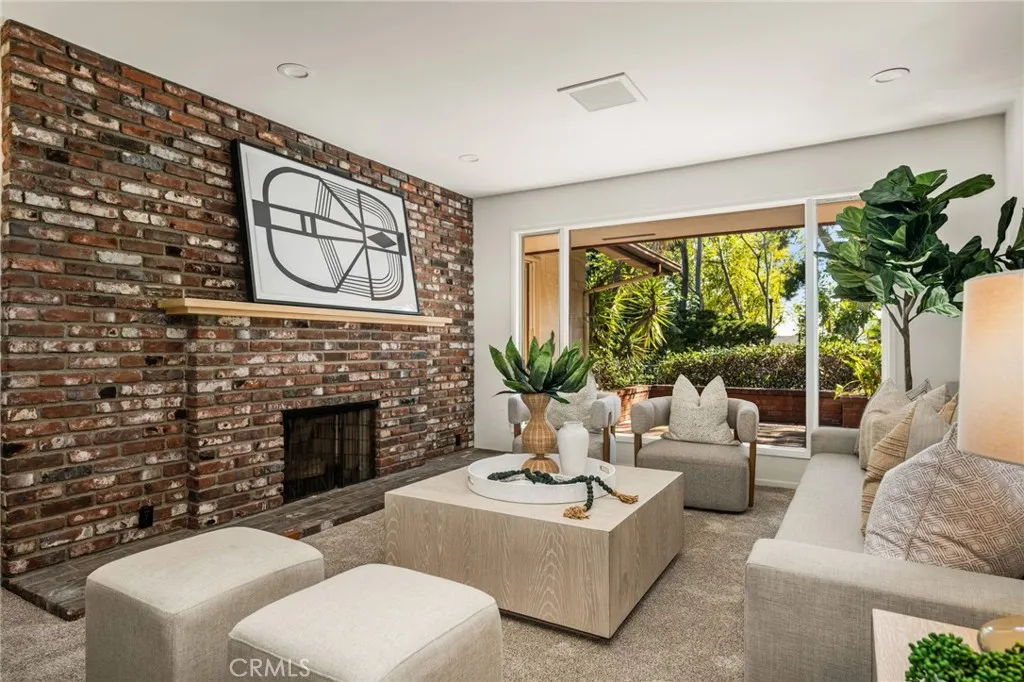 Wall of glass and brick fireplace in the Living Room