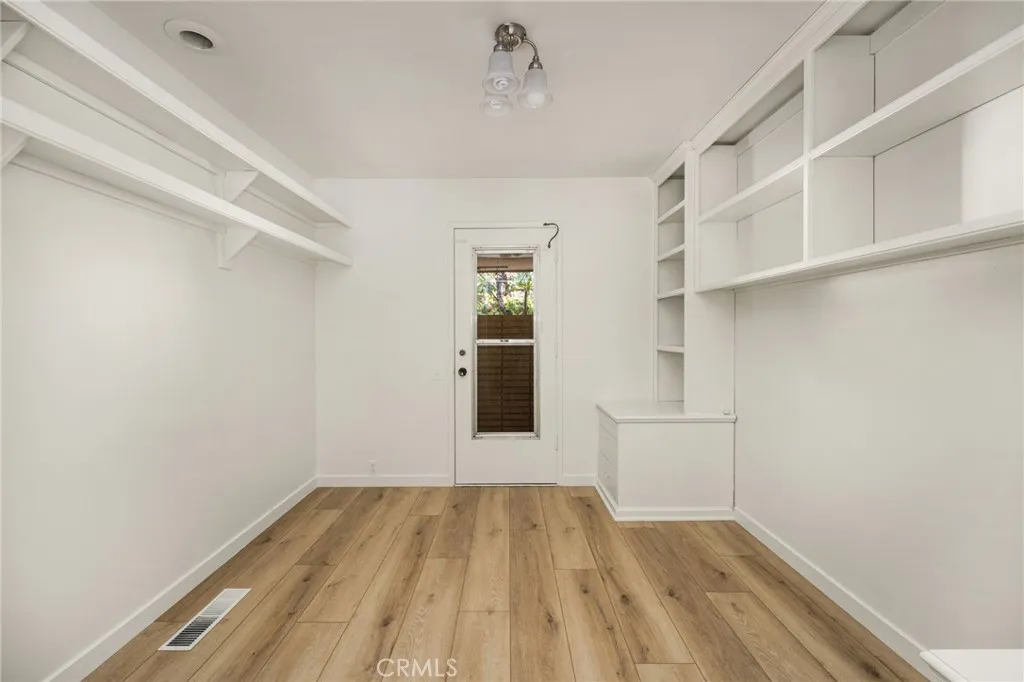 A fifth room (10 x 10 - photo does not reflect size) offers built in drawers and shelvng, new Lux vinyl wood plank floors and a its own private entrance.