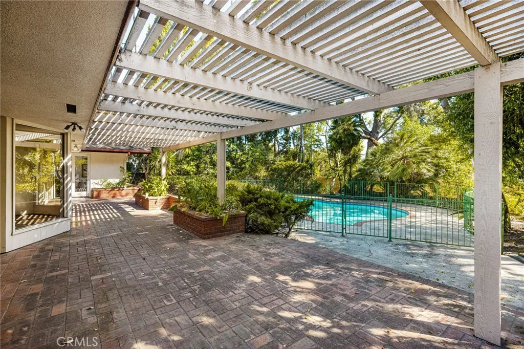 A charming brick patio spans the length of the home. A portion (not shown) is fully covered for dining al fresco all year long.