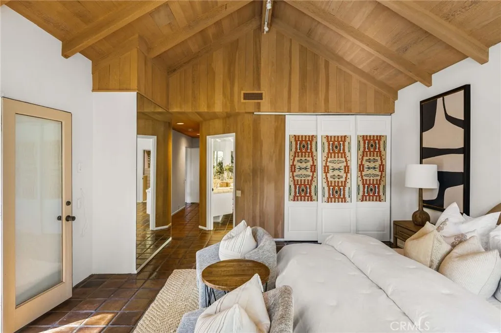 Behind the upolstered closet doors is a built in desk and more storage.