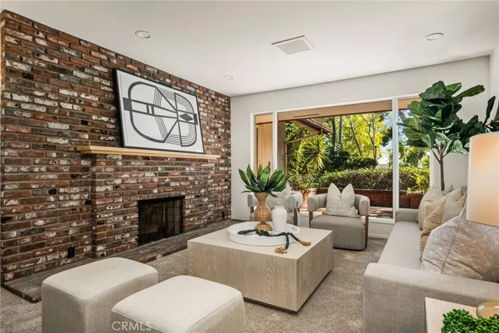 Wall of glass and brick fireplace in the Living Room