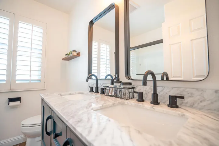 GUEST BATHROOM FEATURES DOUBLE SINKS