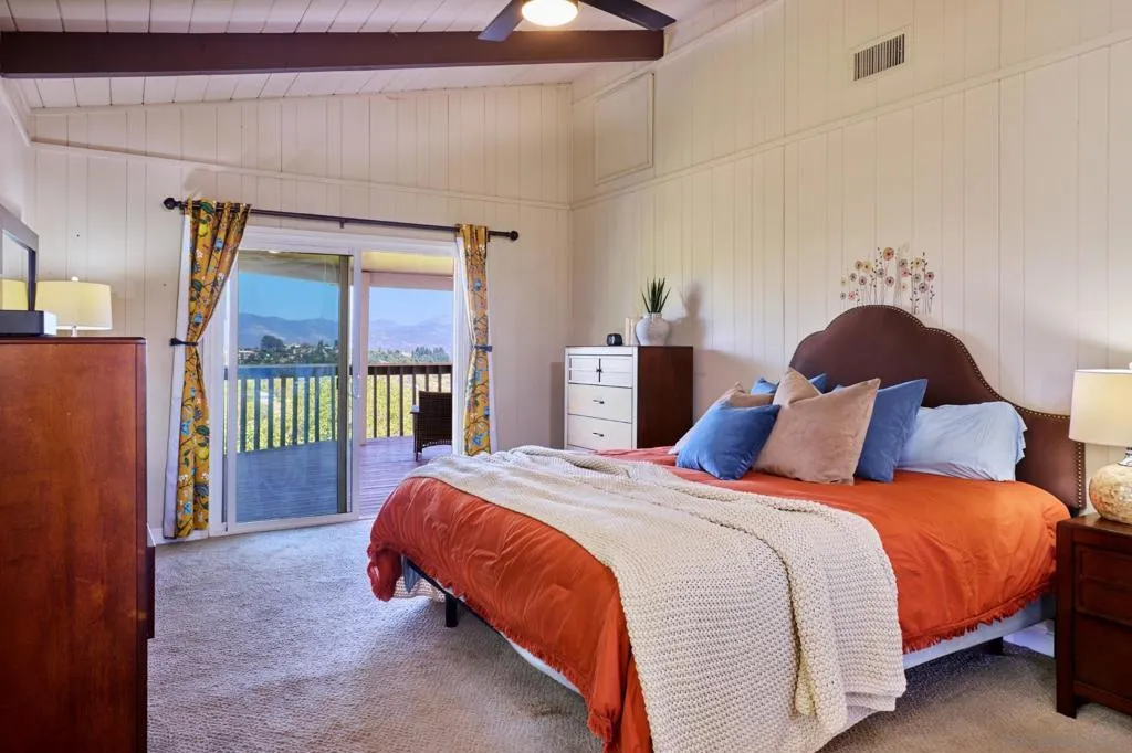 Master bedroom with master bath and access to covered, wraparound deck.