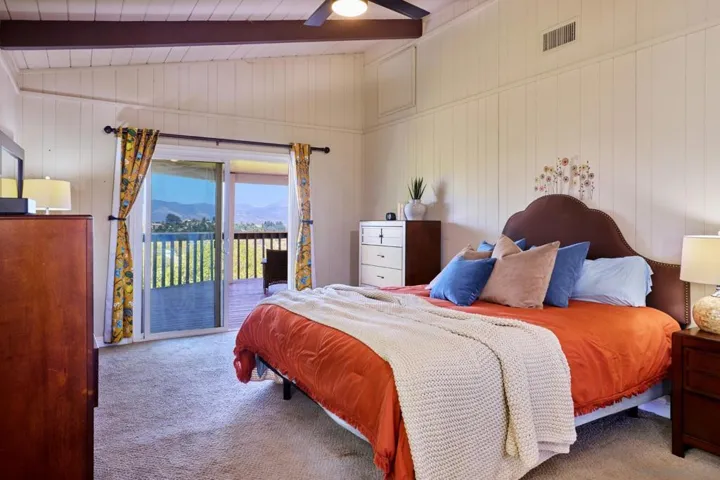 Master bedroom with master bath and access to covered, wraparound deck.