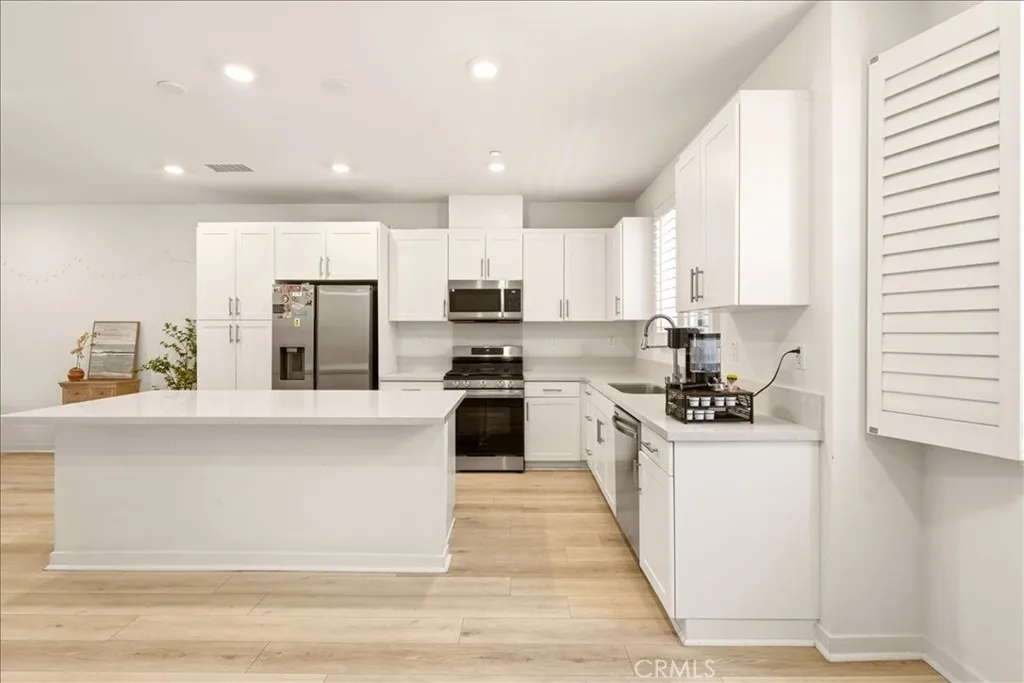 Open concept kitchen flows seamlessly to living room. Big Kitchen island with quartz counter top