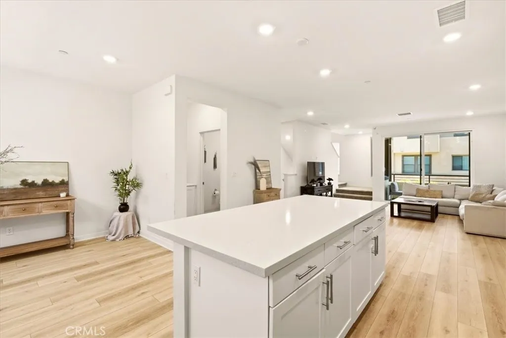 Open concept kitchen flows seamlessly to living room. Big Kitchen island with quartz counter top