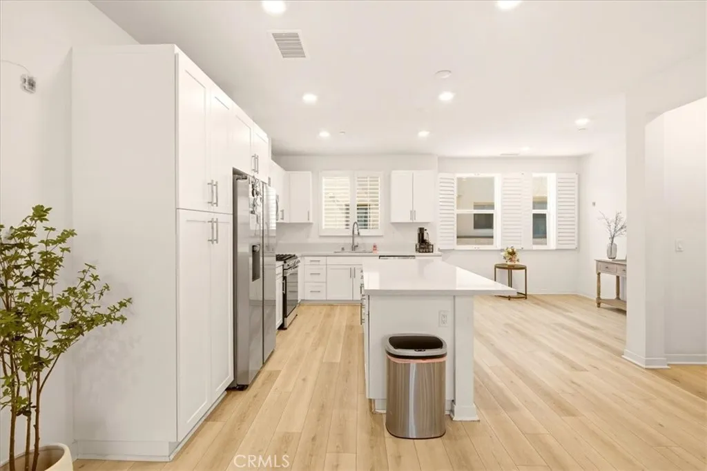 Open concept kitchen flows seamlessly to living room. Big Kitchen island with quartz counter top