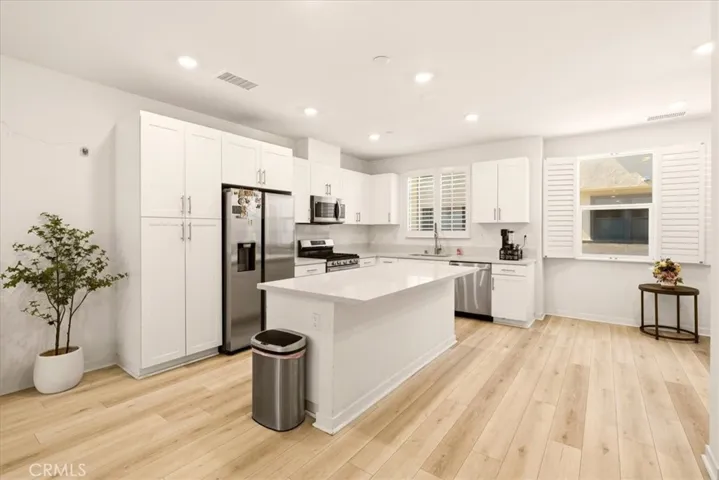Open concept kitchen flows seamlessly to living room. Big Kitchen island with quartz counter top