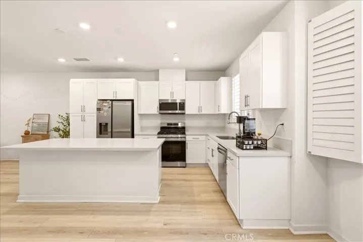 Open concept kitchen flows seamlessly to living room. Big Kitchen island with quartz counter top