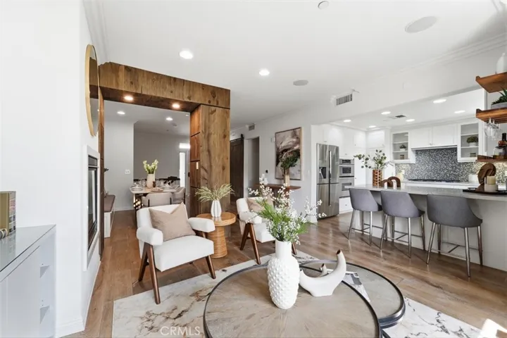Living opens to the balcony, kitchen and dining room.