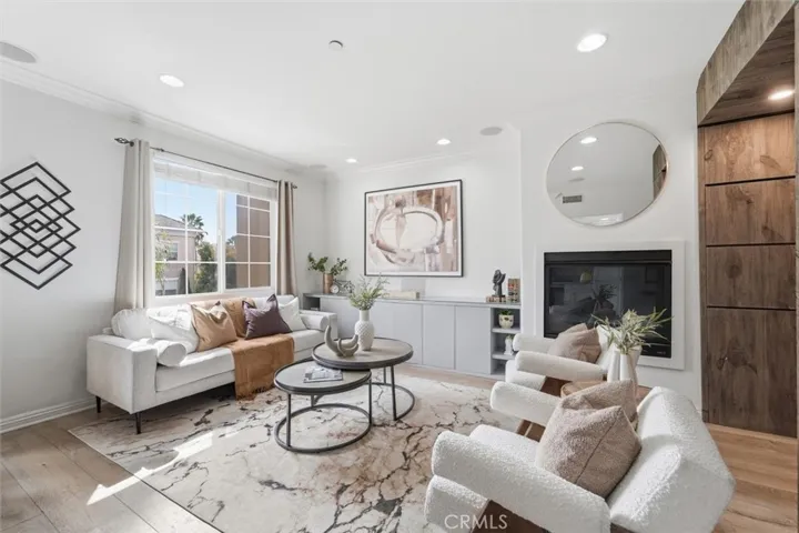 Living opens to the balcony, kitchen and dining room.