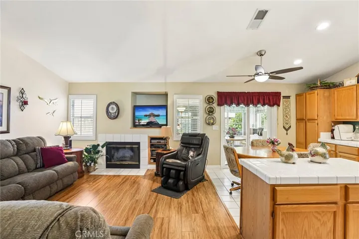 Family Room with Beautiful Flooring, Cozy Fireplace & Plantation Shutters