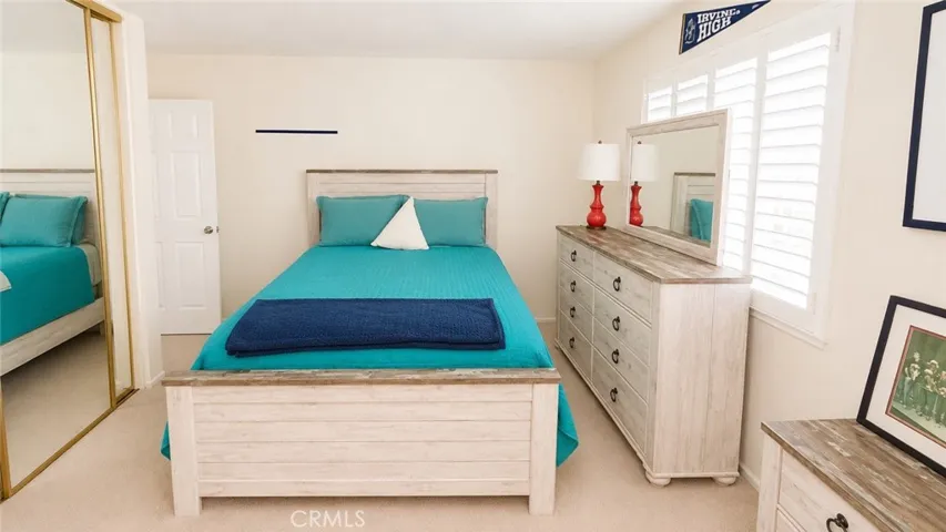 Bedroom with mirrored closet doors.