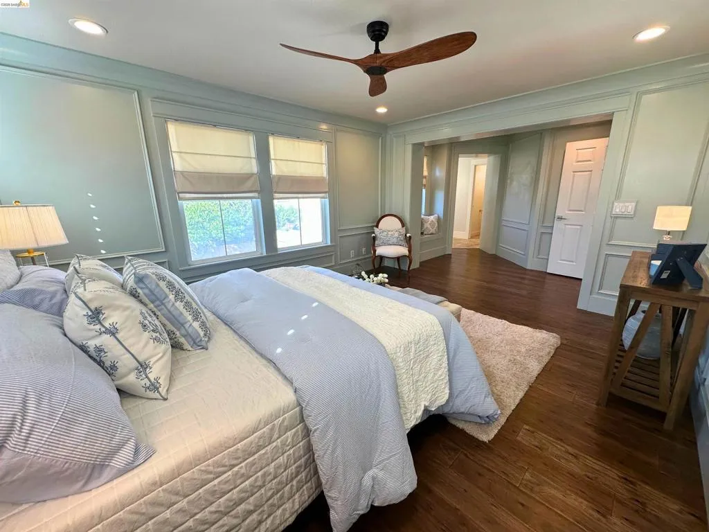 Spacious room featuring rich wood-finish flooring, recessed lighting, and a modern ceiling fan